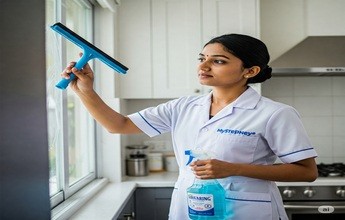 Maid cleaning windows or a specific kitchen appliance